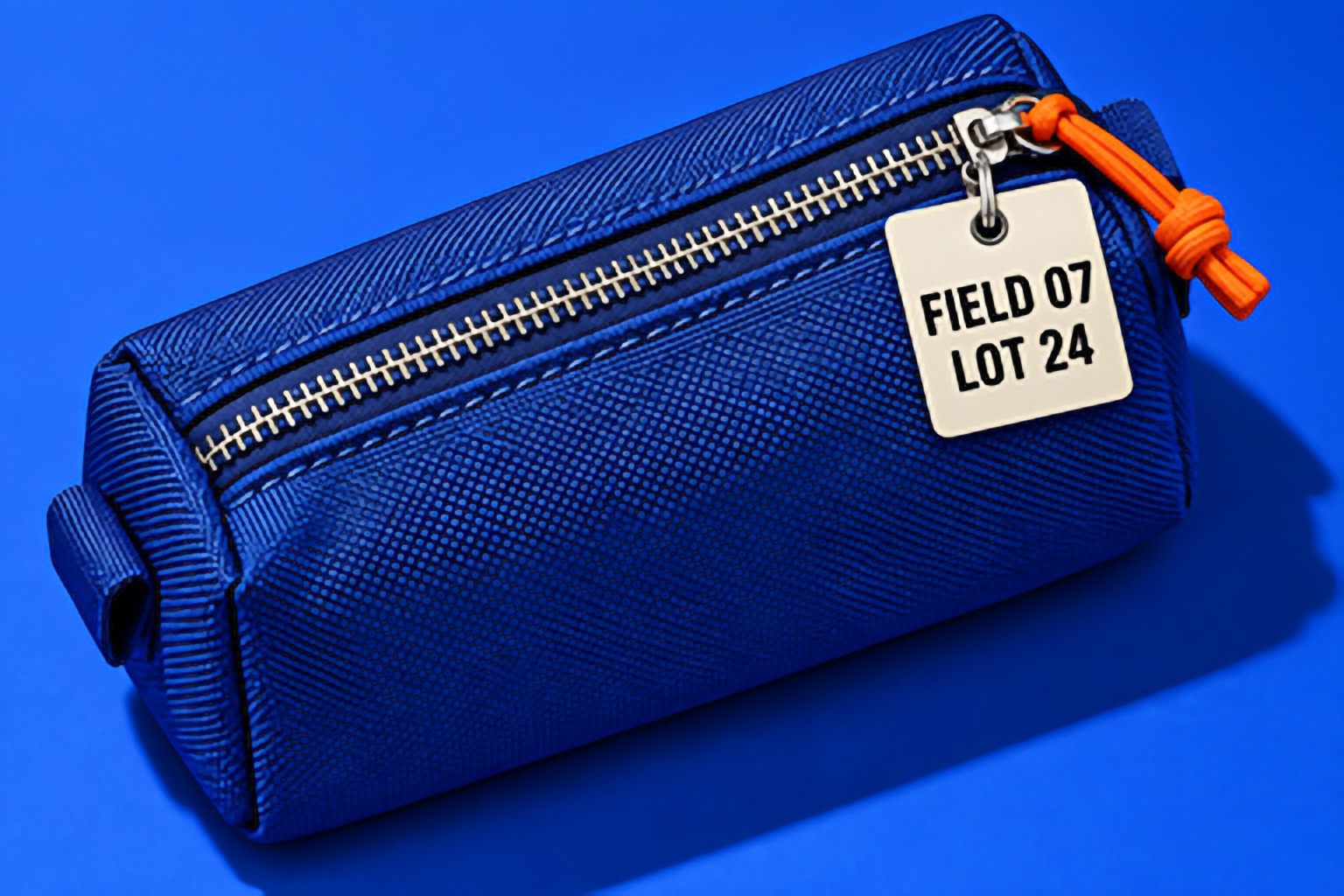 The whole 384 by 256 pixel product photo of a blue pouch enlarged 4 times by MacnifyIt with Enhance (AI)
